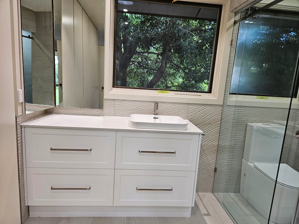 Double-drawer shaker vanity with vessel basin and large window